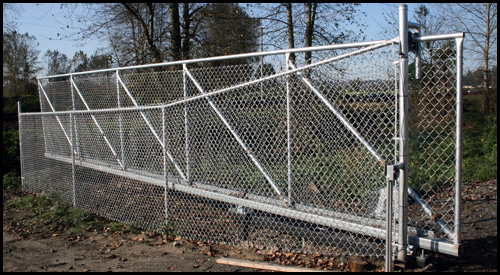 CHAIN LINK CANTILEVER DRIVEWAY GATE IN OPEN POSITION